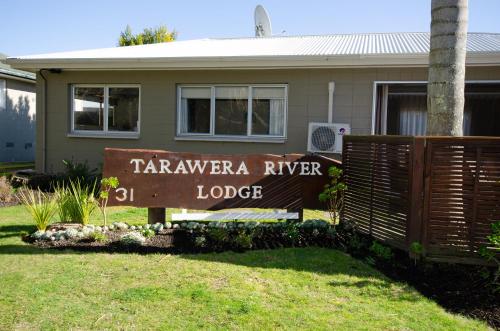 a sign for tarvensea river lodge in front of a house at Tarawera River Lodge Motel in Kawerau