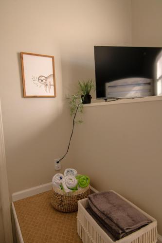a room with two baskets of towels and a shelf at Savannah Lakefront Retreat near Tybee Beach with King Bed and Free Parking in Savannah