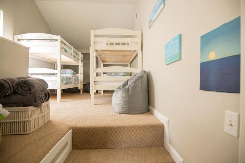 a room with two bunk beds and a staircase at Savannah Lakefront Retreat near Tybee Beach with King Bed and Free Parking in Savannah