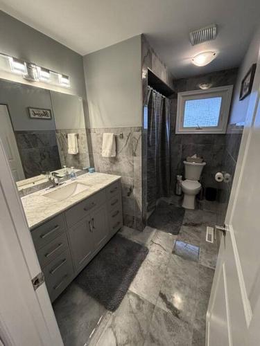 a bathroom with a sink and a toilet at Full House - 5 Bed, 2 Bath - East in Windsor