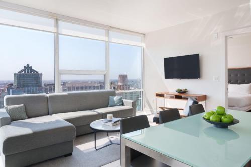 a living room with a couch and a table at Level Los Angeles - Downtown South Olive in Los Angeles