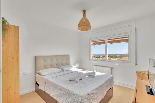 a bedroom with a bed with a teddy bear on it at Sea View Penthouse in Vilanova i la Geltrú