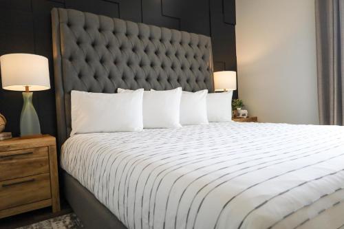 a bedroom with a large bed with a large headboard at Xhale Resort & Spa - ADULTS ONLY RESORT in Idaho Falls