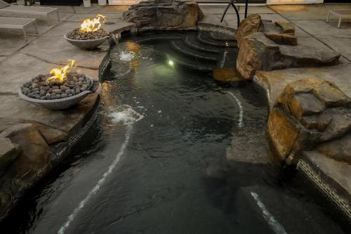 a pond with three bowls with candles in it at Xhale Resort & Spa - ADULTS ONLY RESORT in Idaho Falls