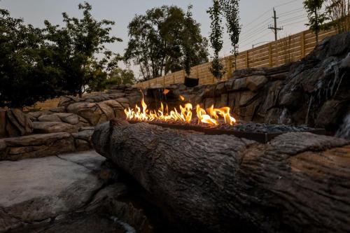 a fire pit in a stone wall with flames at Xhale Resort & Spa - ADULTS ONLY RESORT in Idaho Falls