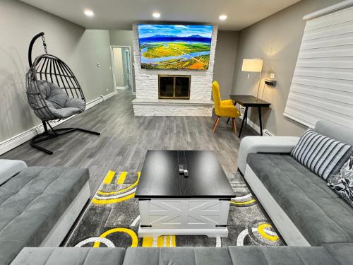 a living room with a couch and a fireplace at 5 Star Luxury Stay Near Chicago O'hare in Des Plaines