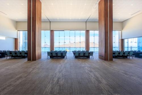 a large room with chairs and large windows at Courtyard by Marriott Mazatlan Beach Resort in Mazatlán