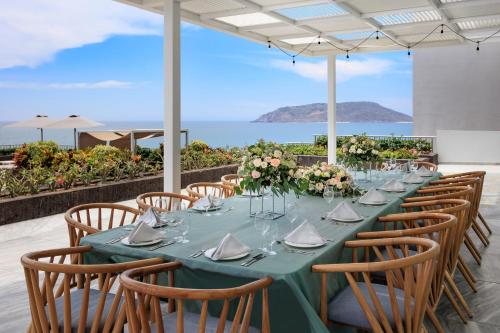 a long table with chairs and a blue table cloth at Courtyard by Marriott Mazatlan Beach Resort in Mazatlán
