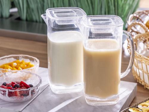 two glasses of milk and a bowl of fruit at Tokyu Stay Sapporo Odori in Sapporo