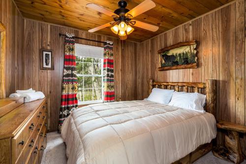 a bedroom with a bed and a ceiling fan at Mountaintop Views, Hot Tub, Deck, Fire Pit & WiFi in Augusta