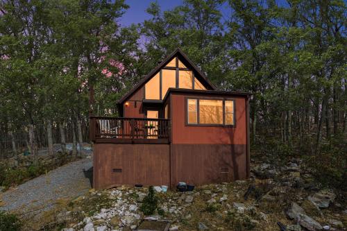 a small house in the middle of a forest at Mountaintop Views, Hot Tub, Deck, Fire Pit & WiFi in Augusta