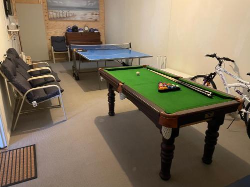 a room with a pool table and a ping pong ball at McCracken Homestay in McCracken