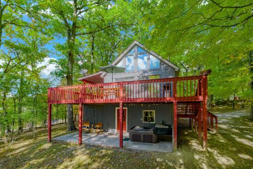 a tiny house in the woods with a red roof at Hot Tub, Large Deck, WiFi, Fire Pit at Chalet Cabin in Morton Grove