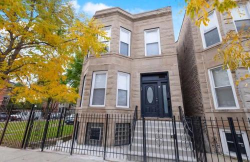 a house with a black door and a fence at Chicago Avenue Inn in Chicago