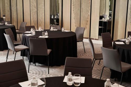 a dining room with tables and chairs and tablesktop at The Luxury Collection Hotel Manhattan Midtown in New York