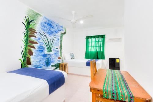 a room with two beds and a bench in it at HOTEL LAS COLORADAS in Yuluc