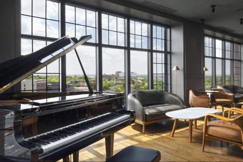 a piano in a room with large windows at The Westin Portland Harborview in Portland