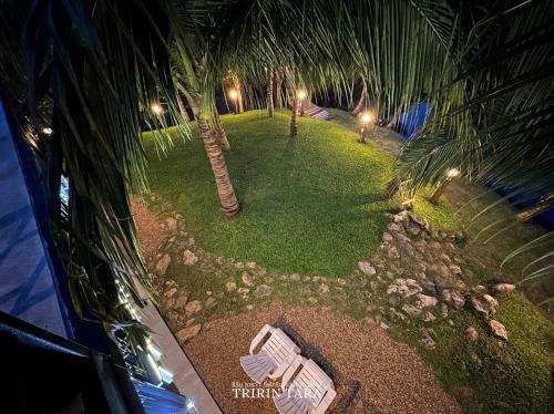 an aerial view of a garden with palm trees at night at ธีริน ธารา - ที่พักริมแม่น้ำแควใหญ่ (TRIRIN TARA) in Ban Tha Pong (1)