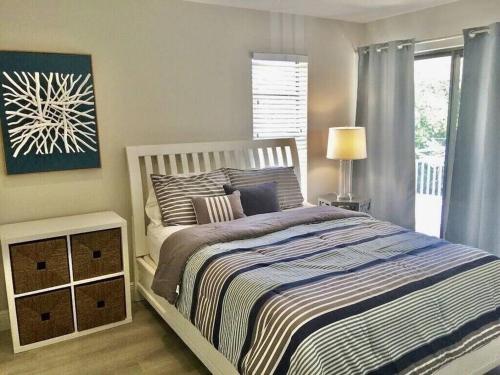a bedroom with a large bed and a window at KAWAMA K1 in Key Largo, Beach, Lagoon, Pools, Tennis, Free Bikes and Canoes in Key Largo