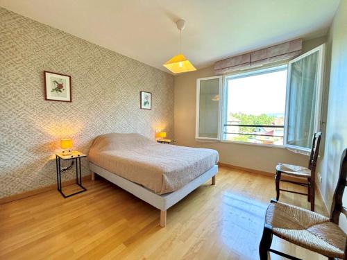 une chambre avec un lit, une fenêtre et une chaise dans l'établissement Appartement calme avec parking proche du lac à Annecy - FR-1-432-88, à Annecy
