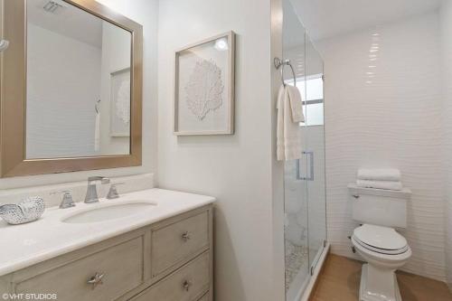 a bathroom with a sink and a toilet and a mirror at KAWAMA L4 in Key Largo, Beach, Lagoon, Pools, Tennis and Free Bikes in Key Largo