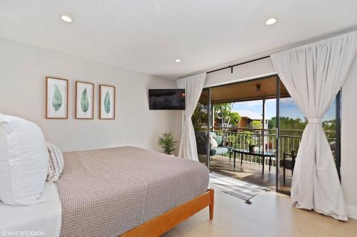 a bedroom with a bed and a view of a balcony at KAWAMA L4 in Key Largo, Beach, Lagoon, Pools, Tennis and Free Bikes in Key Largo