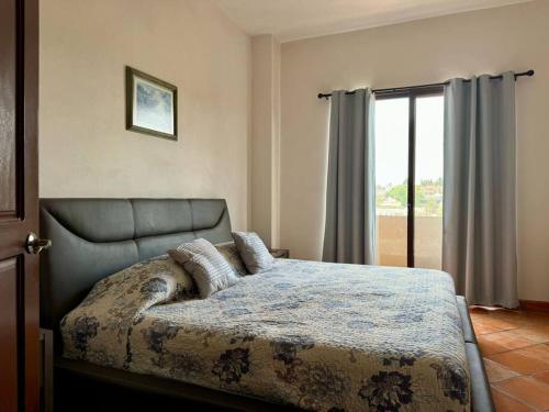 a bedroom with a bed and a large window at Charming No Stairs Near DT Security Pool Parking in San Miguel de Allende