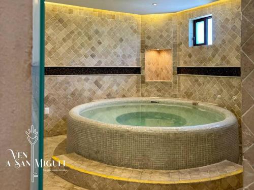 a bathroom with a jacuzzi tub in a room at Charming No Stairs Near DT Security Pool Parking in San Miguel de Allende
