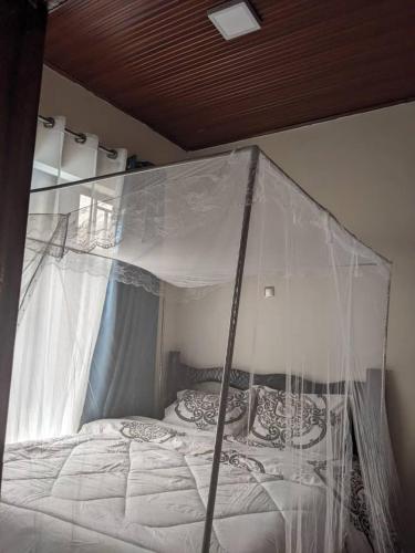 a bed with a canopy in a bedroom at New look apartment in Bugesera