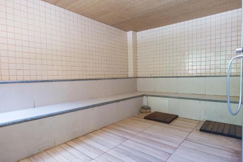a room with a bathtub and a dog sitting in it at Hotel Vila Suíça 1818 in Nova Friburgo