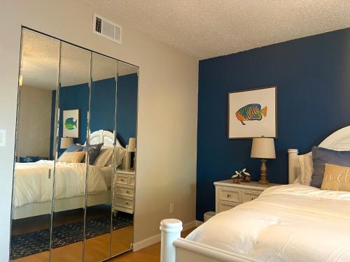 a bedroom with two beds and a mirror at Cozy Spot, 5 Min Away from Beach in Largo