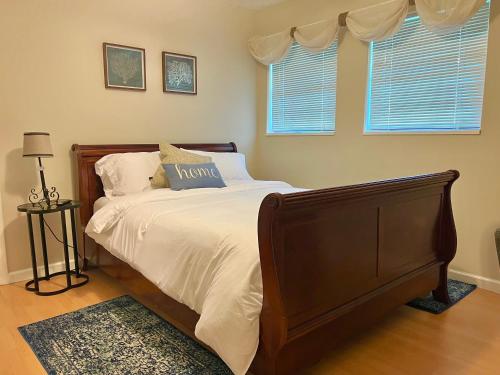 a bedroom with a large bed with white sheets and pillows at Cozy Spot, 5 Min Away from Beach in Largo