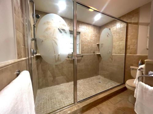 a shower with a glass door in a bathroom at Cozy Spot, 5 Min Away from Beach in Largo