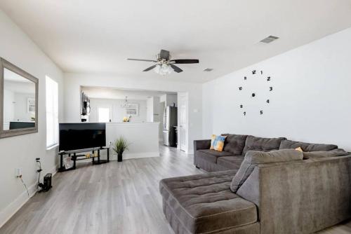 a living room with a couch and a flat screen tv at Serenity Home Near Downtown & Airport in Austin
