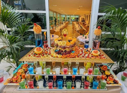 a buffet of food and drinks on a table at Hotel Mediterraneo in Lignano Sabbiadoro