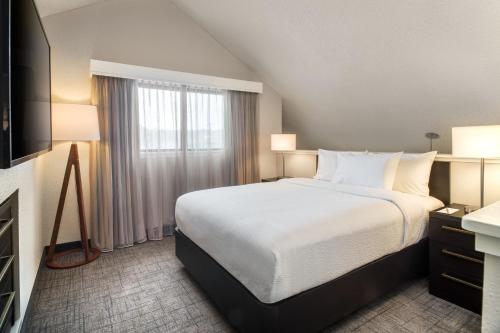 a hotel room with a bed and a window at Residence Inn by Marriott Long Beach in Long Beach