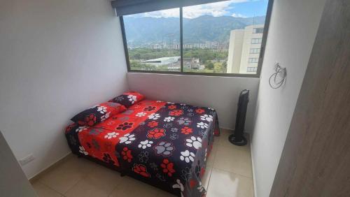 a small bedroom with a bed and a window at Apartamento Wakari- Ibagué- Cerca del Parque Deportivo in Ibagué