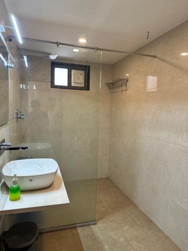 a bathroom with a sink and a glass shower at Hotel Relax Inn in Bānswāra