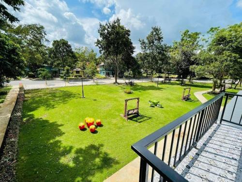 a view of a park from a balcony at Goldengold (Khaoyai) Resort & Spa in Mu Si