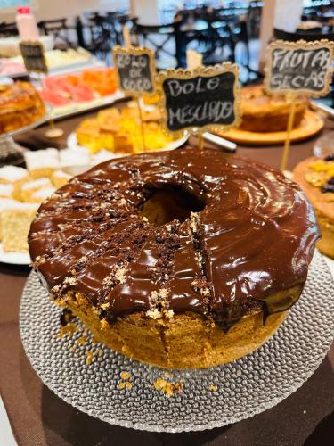 a chocolate covered cake on a plate on a table at Hotel Vila Suíça 1818 in Nova Friburgo