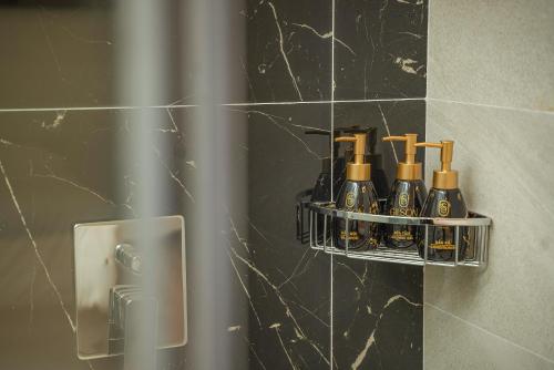 a bathroom with a shelf with bottles of wine at Gilson Hanoi Hotel in Hanoi