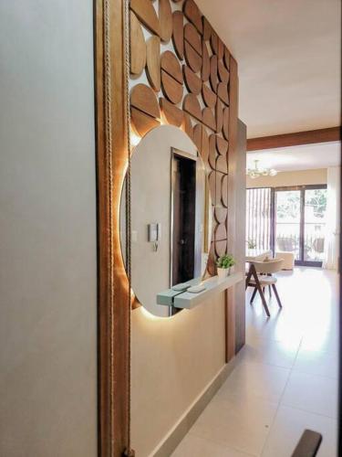 a mirror on a wall in a living room at Luxury Apartment Downtown in Santiago de los Caballeros