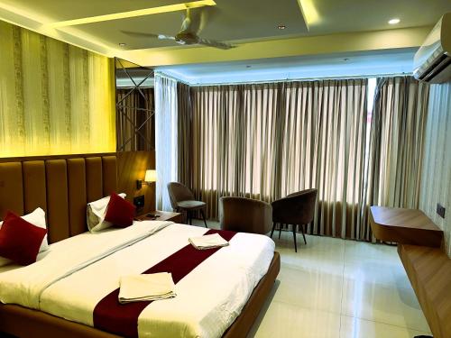 a hotel room with a bed and a table and chairs at Hotel Relax Inn in Bānswāra