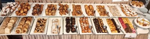 a bunch of different types of food on a table at Hotel Mediterraneo in Lignano Sabbiadoro