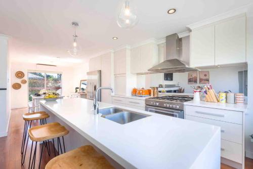 a kitchen with white cabinets and a white counter top at Lucys Place By Swan Bnb Management in Albany
