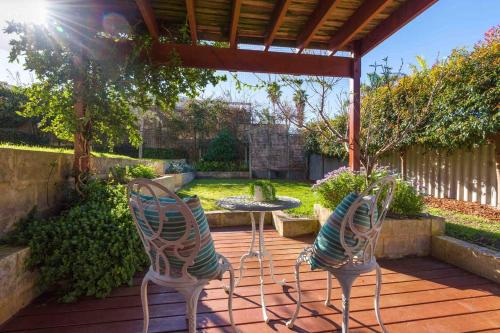 two chairs and a table on a patio at Lucys Place By Swan Bnb Management in Albany