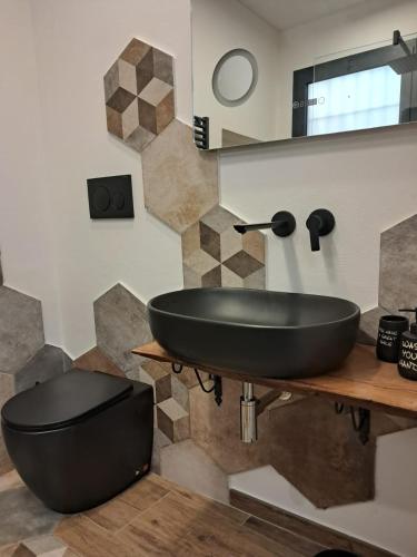 a bathroom with a black sink on a counter at Re Giocondo Room in Foiano della Chiana