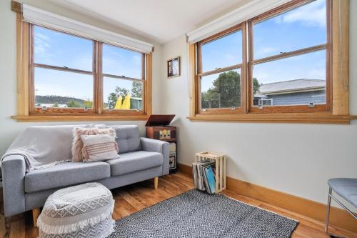 a living room with a couch and two windows at Beach Holiday Home-Close to Airport-3 Bed & 2 Bath in Lauderdale