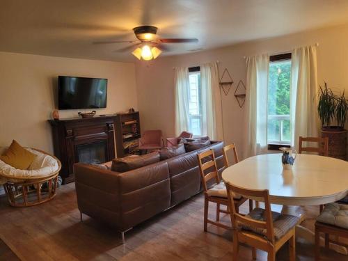 a living room with a couch and a table at Farmhouse in Simcoe