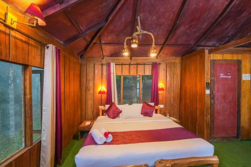 a bedroom with two beds in a room at Nature Zone Jungle Resort in Munnar